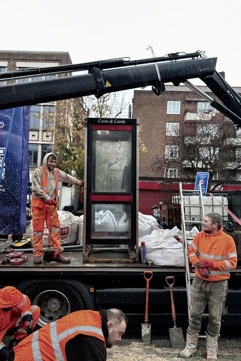 Photo of KX100 phonebox being removed by workmen and loaded onto a truck